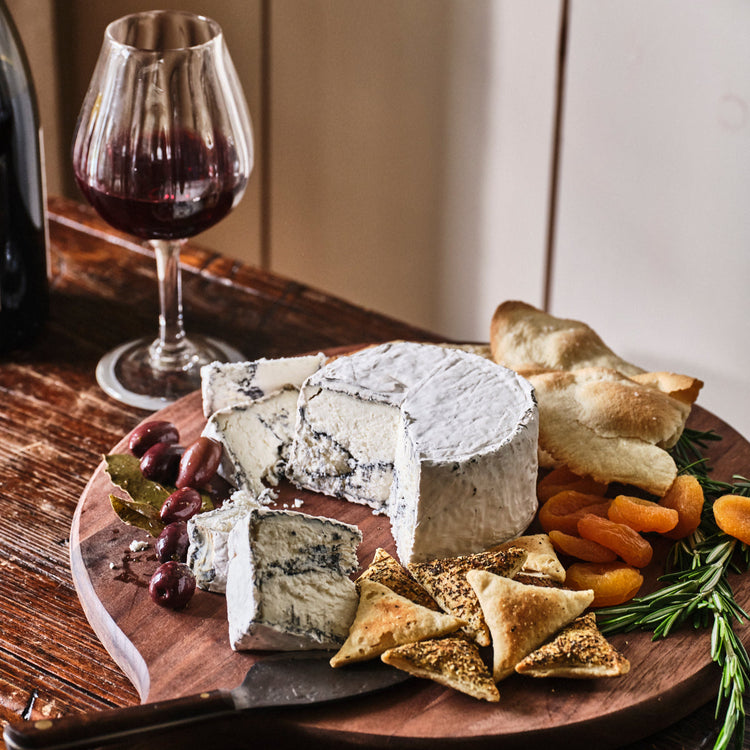 hawkins haze on a cheese board with a glass of wine