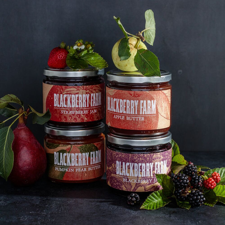 Jars of Blackberry Farm apple butter with a dark background