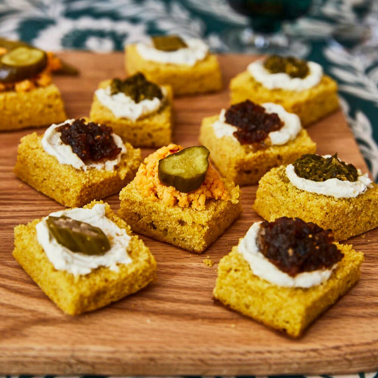 Small cornbread appetizers on a wooden board 
