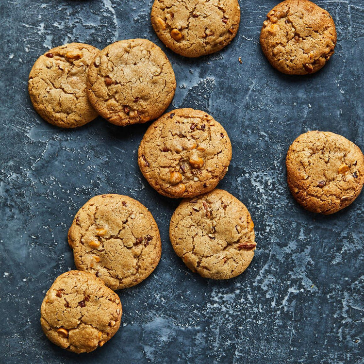 Cookies scattered on a textured dark surface
