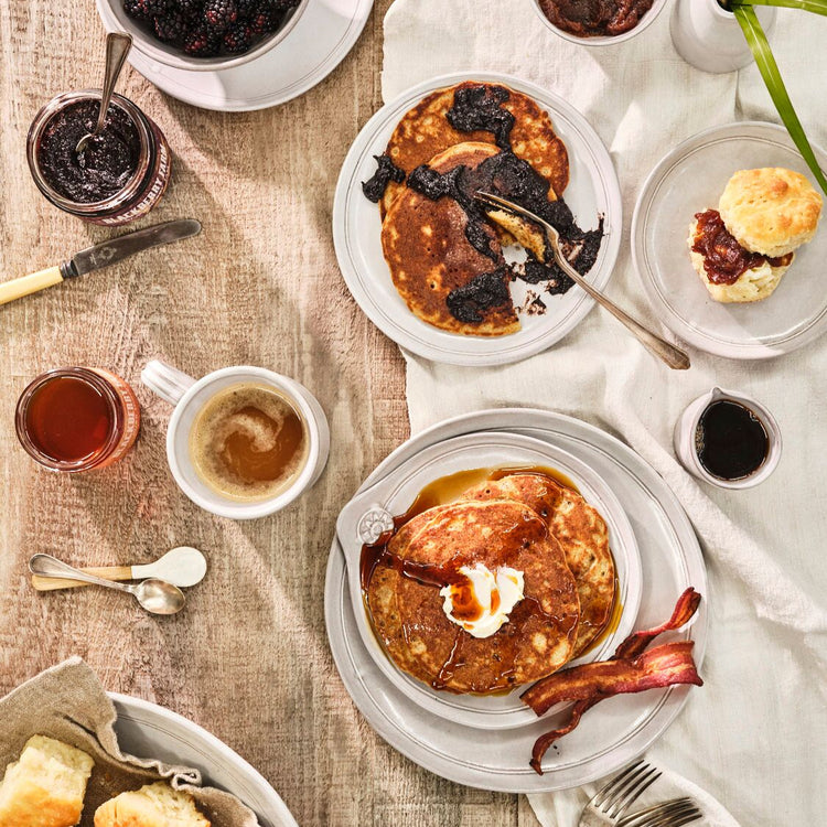 breakfast spread with griddle cakes and biscuits